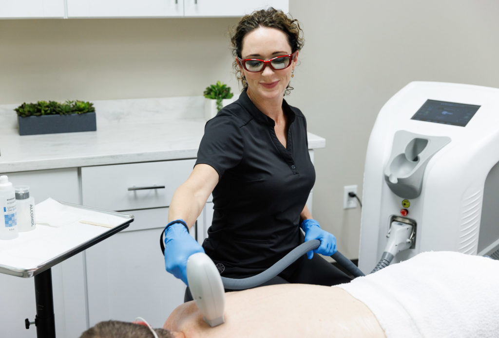 practitioner doing laser hair removal
